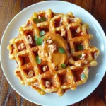 pumpkin pecan waffles served with peanut butter and chopped nuts.