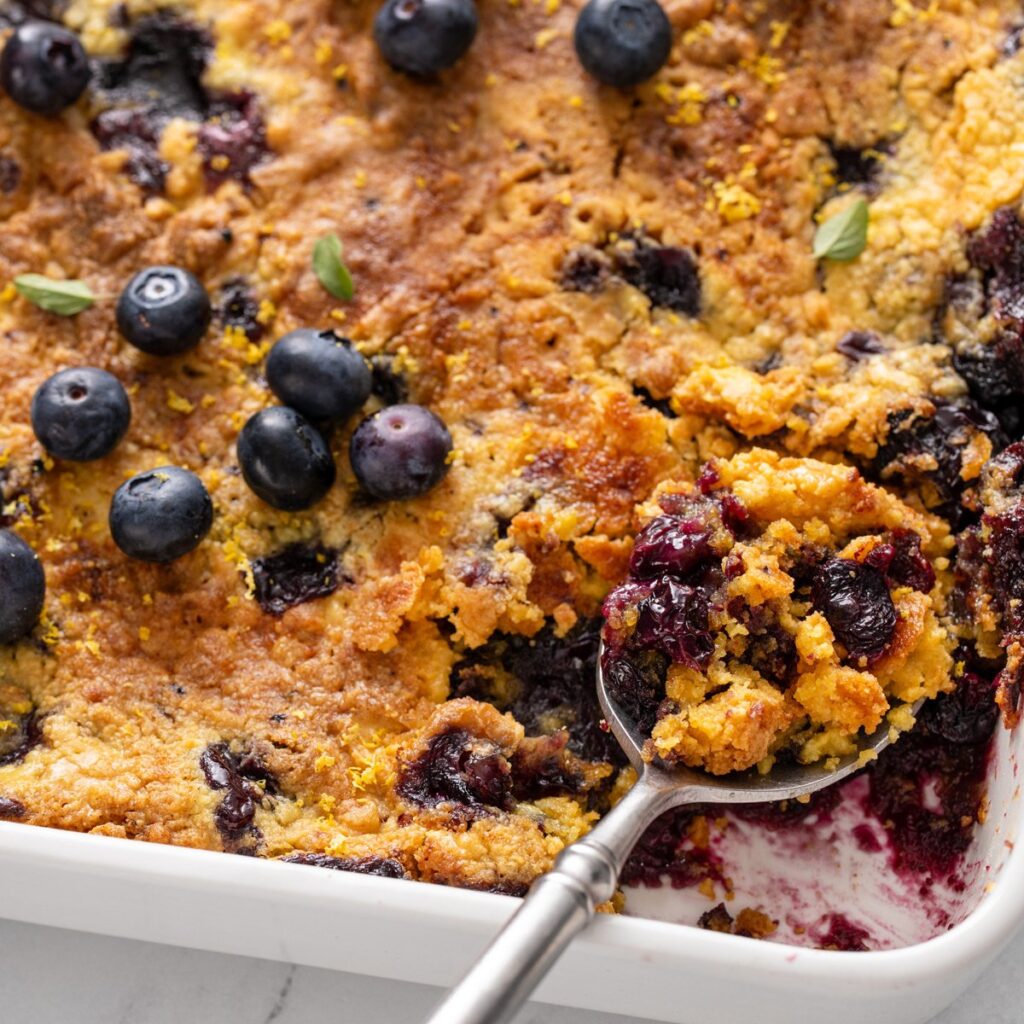 spoon in blueberry dump cake hero - Delicious Blueberry Dump Cake Recipe